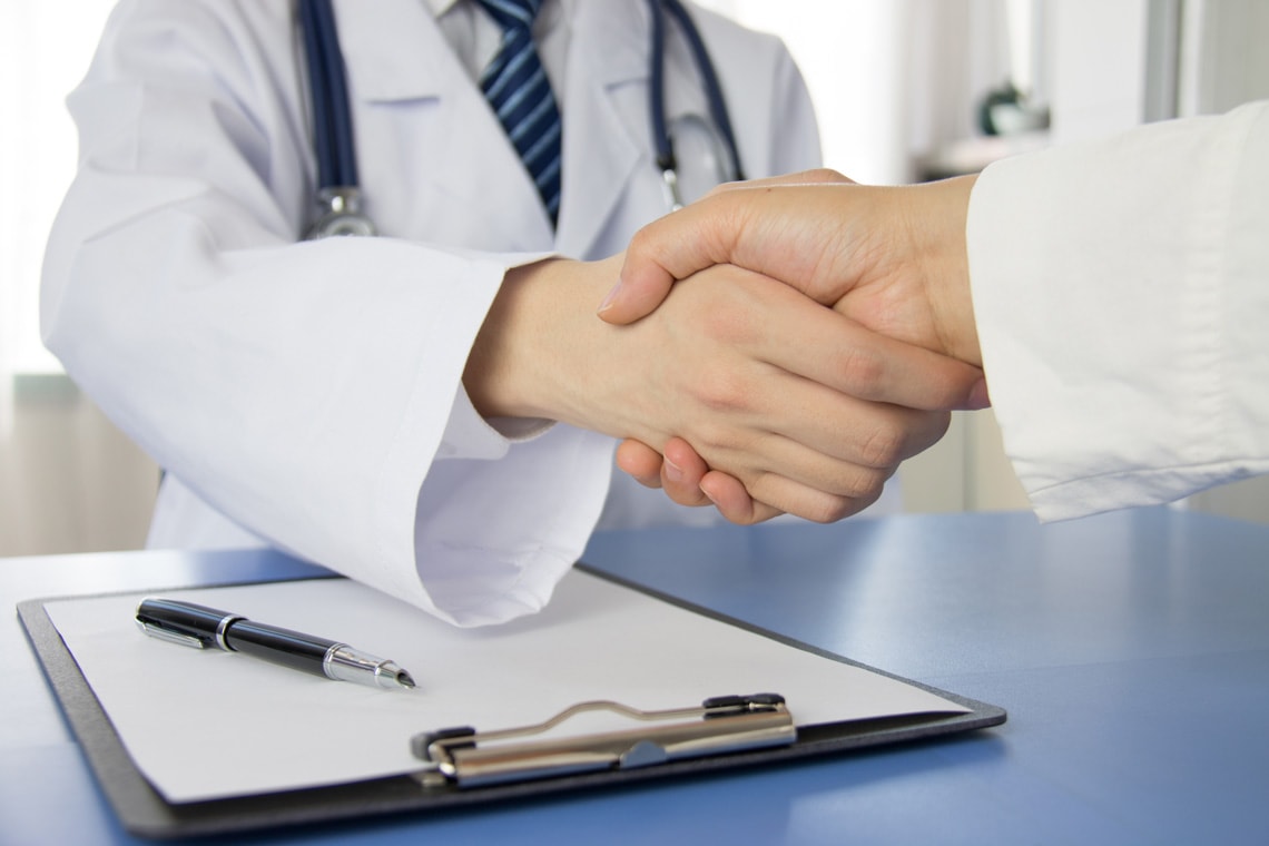 doctor-and-businessman-shaking-hands